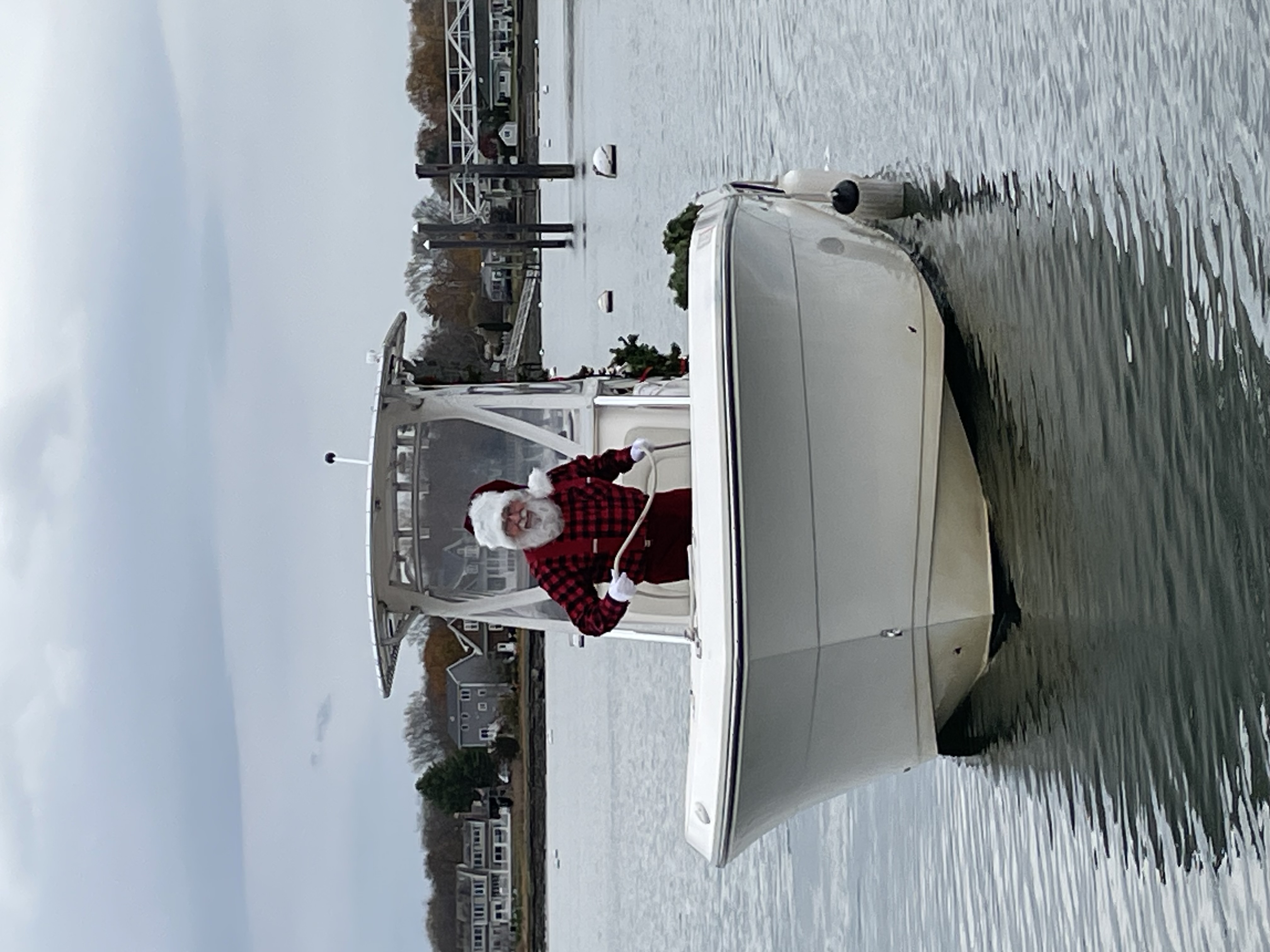 Santa Ricky reading to children gathered close, gentle ambient glow.